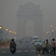 Traffic moves in front of the landmark India Gate monument enveloped by a blanket of smog, caused by a mixture of pollution and fog, in New Delhi, India, Tuesday, Nov. 6, 2012. Environmentalists say that the level of pollution in the city has reached an alarming level, according to news reports.